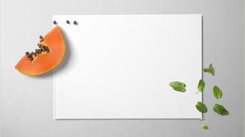 Papaya and mint on white paper on isolated background photo