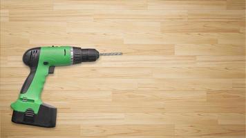 Drill machine on wooden background photo