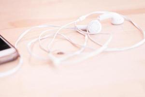 White earphones on neutral background photo