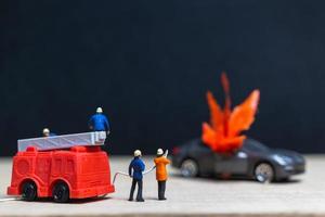 Miniature firefighters at a car accident, car accident concept photo