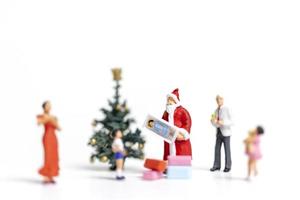 Papá Noel en miniatura con regalos para una familia feliz, Navidad y feliz año nuevo concepto foto