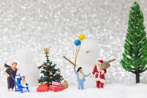 Miniature Santa Claus and kids with a snow background, Christmas and Happy New Year concept photo