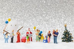 Miniature Santa Claus and kids with a snow background, Christmas and Happy New Year concept photo