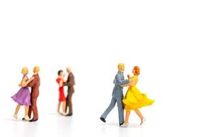 Miniature people dancing on s white background, Valentine's Day concept photo