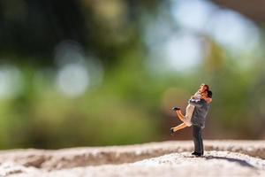 Miniature couple standing in the park photo