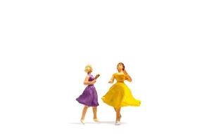 Miniature people dancing on a white background photo