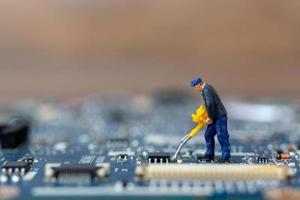 Miniature person working on a CPU board, technology concept photo