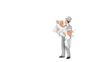 Miniature wedding bride and groom isolated on a white background photo