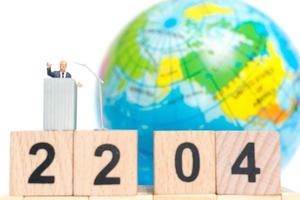 Miniature businessman speaking on the podium about Earth Day photo