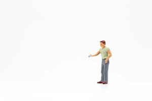 Miniature person standing on a white background photo