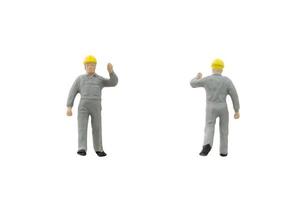Miniature construction workers on a white background photo