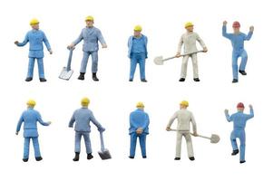 Miniature construction workers on a white background photo