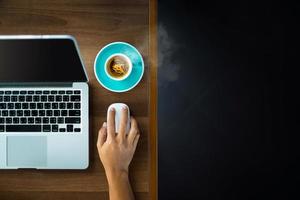 Top view of a businessman using a laptop with coffee photo