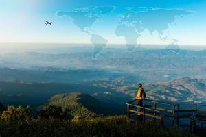 concepto de viaje con el hombre en la cima de la montaña foto