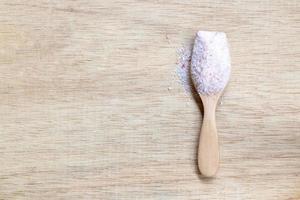 Himalayan pink salt on a wooden background photo