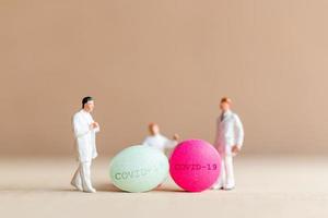 Miniature doctor researching and developing a Coronavirus vaccine, medicine to stop the COVID-19 outbreak concept photo