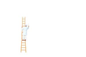 Miniature person with a ladder holding a brush in front of a white wall background photo