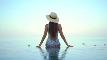 Young Asian Woman Relaxes Around Infinity Pool video