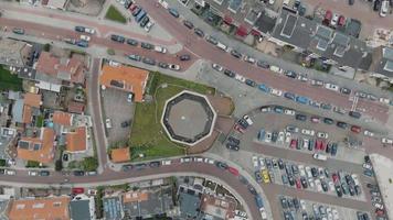 Aerial bird's-eye footage of the densely populated city of Zandoort, Netherlands along the North Sea.