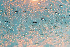 Abstract background of blurred water drops and light on glass photo