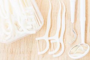 A box of white dental floss on a wooden background photo