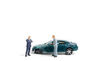 Miniature people at the scene of a car accident, car crash on a white background, drive safely concept photo