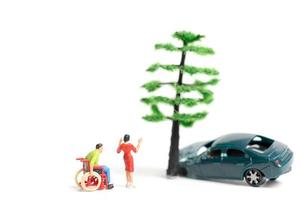 Miniature people at the scene of a car accident, car crash on a white background, drive safely concept