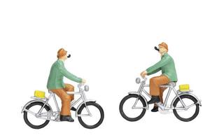 Miniature travelers with bicycles isolated on a white background photo