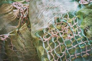 Macrame knots decorating a crumpled shawl photo