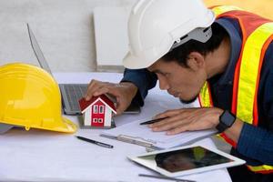 Architectural Engineer designs building construction for a house project photo