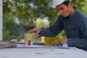 Architectural Engineer designs building construction for a house project photo