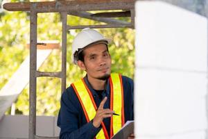 Architectural Engineer inspects quality control on site building photo