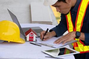 Architectural Engineer designs building construction for a house project photo
