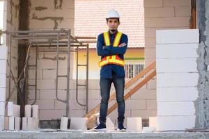 Architectural Engineer stands on site construction photo