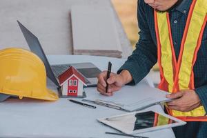 Architectural Engineer designs building construction for a house project photo