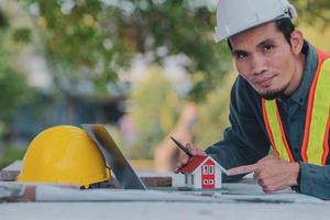 Architectural Engineer designs building construction for a house project photo