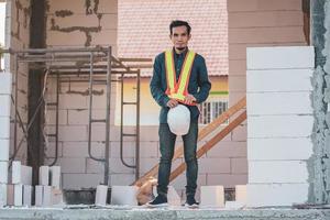 Architectural Engineer stands on site construction photo