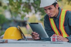 Engineer working on tablet and laptop on site construction photo