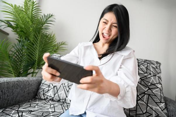 Playing Mobile Game Stock Photos, Images and Backgrounds for Free Download