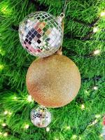Christmas ball hanging on pine branches with a festive background photo