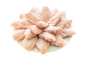 Raw chicken wings on white plate photo