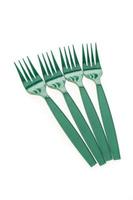 Green plastic forks on white background photo