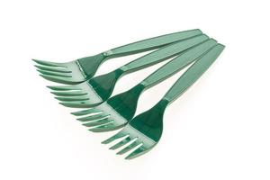 Green plastic forks on white background photo