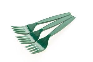 Green plastic forks on white background photo