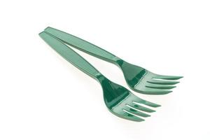 Green plastic forks on white background photo