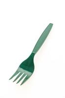 Green plastic fork on white background photo