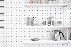 Modern kitchenware and utensils on shelves photo