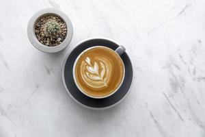 Cappuccino and cactus on marble photo