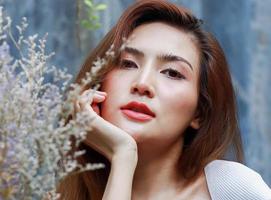 Woman posing near flowers photo