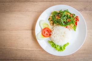 Spicy Fried basil leaf with chicken and rice photo